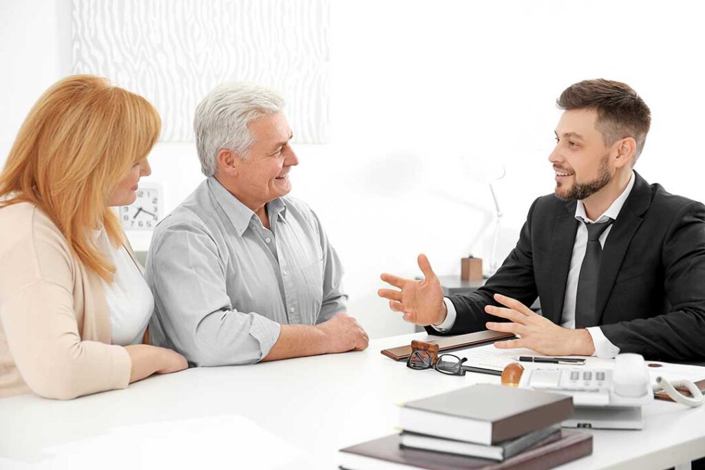 Homeowner reviews a policy beside jewelry, receipts, photographs, and an appraisal document.